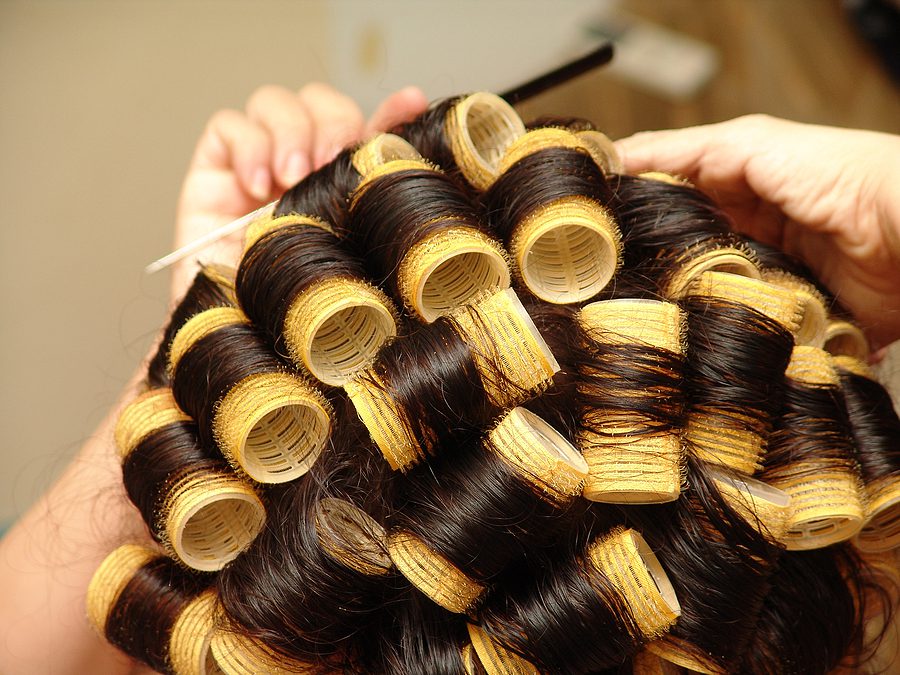 velcro rollers in hair at a salon. Professional styling with rollers