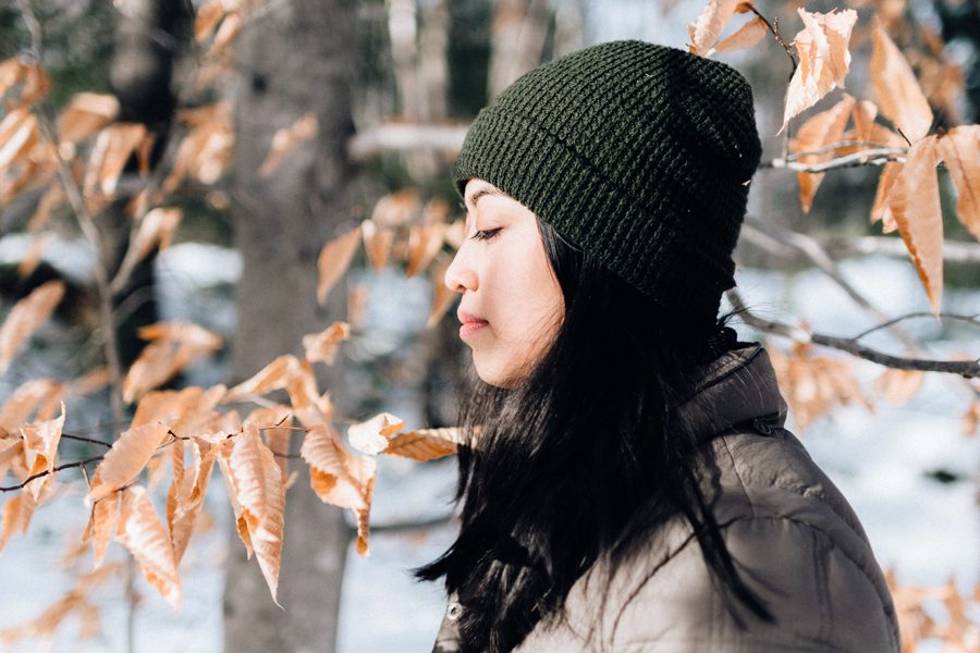 young woman in green wool beanie in the winter