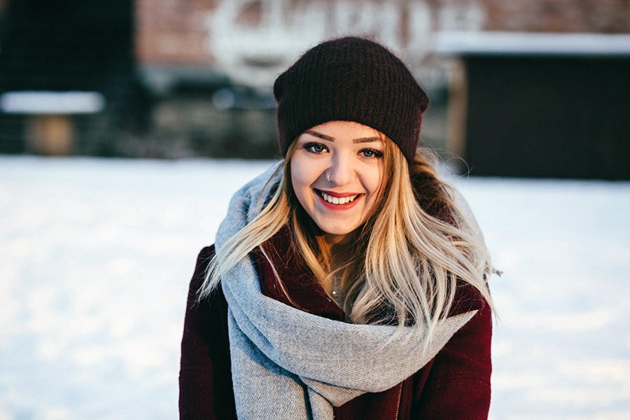 young woman with natural hair shine in a beanie during the Winter